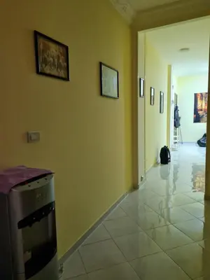 a hallway with yellow walls and a trash can at Oasis Resort Soraya - 2 bed apt, recently renovated and fully furnished with pool views in Al Ahyaa Hurghada Egypt in Hurghada