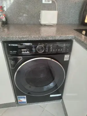 a black washing machine sitting in a kitchen at Oasis Resort Soraya - 2 bed apt, recently renovated and fully furnished with pool views in Al Ahyaa Hurghada Egypt in Hurghada