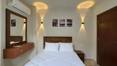 a bedroom with a bed and a mirror and lights at El princess one bedroom hurghada in Hurghada