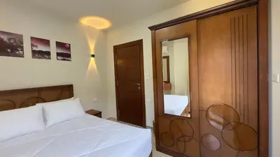 a bedroom with a white bed and a mirror at El princess one bedroom hurghada in Hurghada