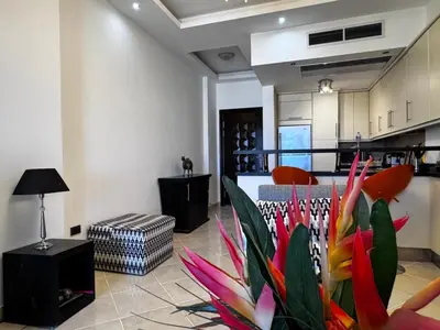 a living room with a colorful plant in the middle at Gravity Apartments Sea View Pool View للأجانب فقط Just For Foreigners in Hurghada