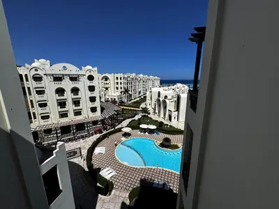 a view from a balcony of a resort with a swimming pool at Gravity Apartments Sea View Pool View للأجانب فقط Just For Foreigners in Hurghada
