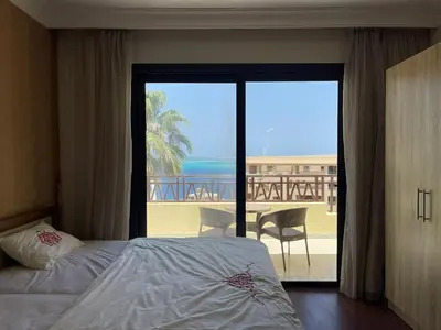 a bedroom with a bed and a view of the ocean at استديو ايجار في الغردقه 206 in Hurghada
