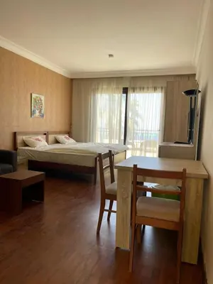 a room with a bed and a table and chairs at استديو ايجار في الغردقه 206 in Hurghada