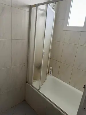 a shower with a glass door in a bathroom at 2 bedroom apartment in Prestige Plaza in Hurghada