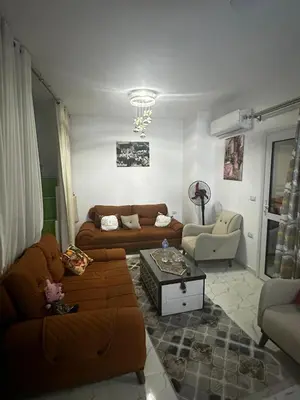 a living room with two couches and a table at 2 bedroom apartment in Prestige Plaza in Hurghada