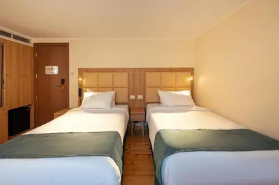 a hotel room with three beds in a room at Shepherd I Dahabya in Esna