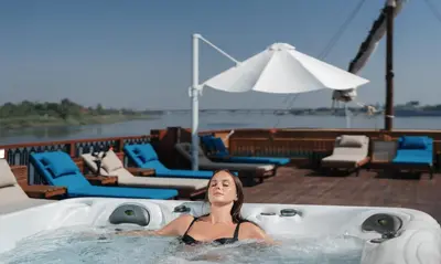 a woman in a hot tub on a boat at Shepherd I Dahabya in Esna
