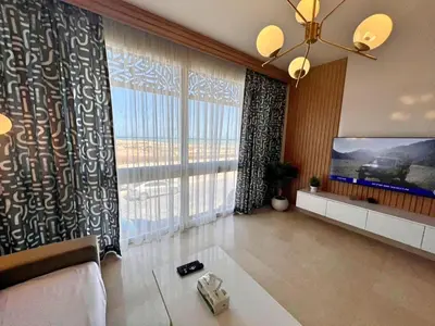 a living room with a couch and a large window at SunShine M9 Mangroovy in Hurghada