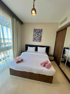 a bedroom with a large bed with two pink pillows at SunShine M9 Mangroovy in Hurghada