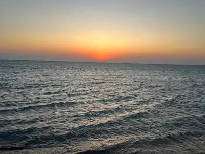 a sunset over a large body of water at SunShine M9 Mangroovy in Hurghada