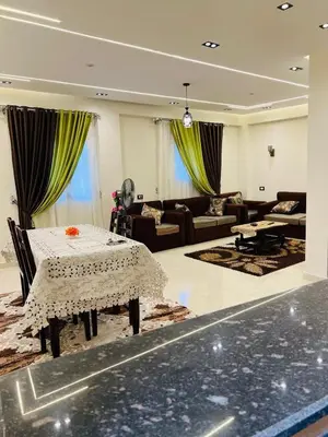 a living room with a table and a couch at Fontana Guste house in Luxor