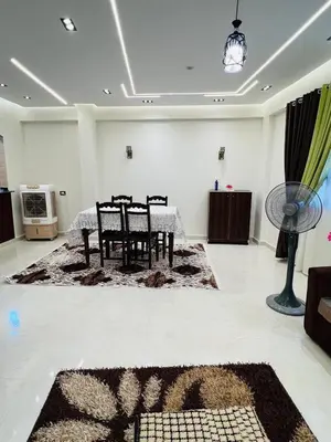 a room with a chair and a table in it at Fontana Guste house in Luxor