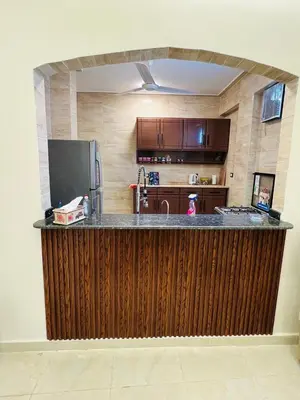a kitchen with a large wooden counter top in a room at Fontana Guste house in Luxor