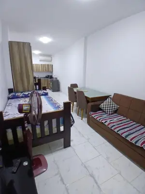 a living room with two beds and a table at Studio in turtels beach e41 in Hurghada