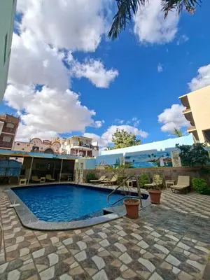 a swimming pool in the middle of a building at Villa Joanna in Luxor
