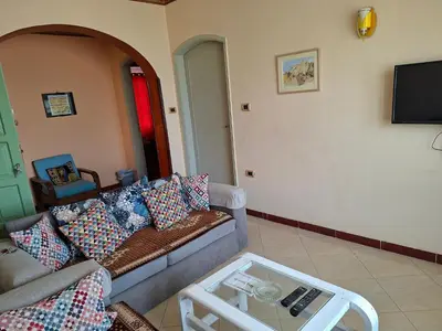 a living room with a couch and a table at Villa Joanna in Luxor