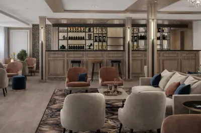 a living room with a bar with a couch and chairs at Five-Stars Deluxe River Kruz from Aswan to Luxor 3 Nights in Aswān