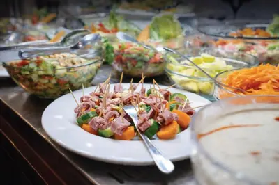 a plate of food on a table with tongs at Five-Stars Deluxe River Kruz from Aswan to Luxor 3 Nights in Aswān