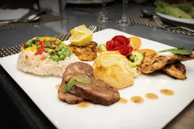 a plate of food with meat rice and vegetables at Five-Stars Deluxe River Kruz from Aswan to Luxor 3 Nights in Aswān