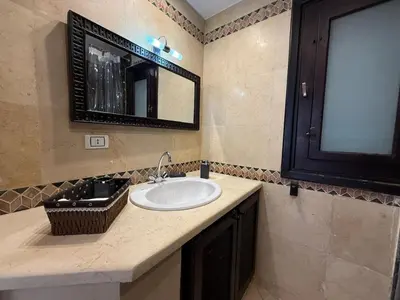 a bathroom with a sink and a mirror at Hillside 4BR Villa, El Gouna Getaway in Hurghada