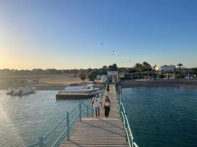 two people walking on a dock in the water at Hillside 4BR Villa, El Gouna Getaway in Hurghada