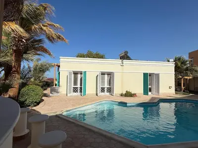 a house with a swimming pool in front of a house at Hillside 4BR Villa, El Gouna Getaway in Hurghada