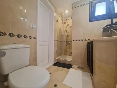 a bathroom with a toilet and a shower at Hillside 4BR Villa, El Gouna Getaway in Hurghada