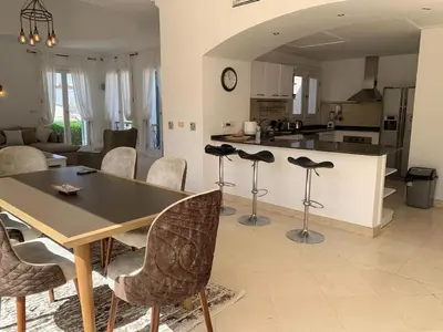 a kitchen and living room with a table and chairs at Unique Hill Villa 3 BD In Gouna in Hurghada