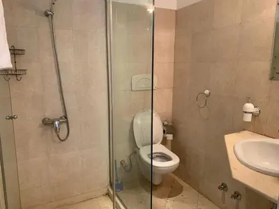 a bathroom with a toilet and a glass shower at Unique Hill Villa 3 BD In Gouna in Hurghada