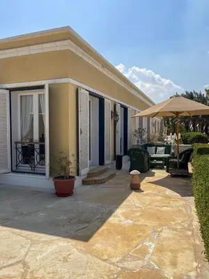 a house with a patio and an umbrella at Unique Hill Villa 3 BD In Gouna in Hurghada