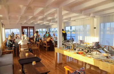 a group of people sitting in a restaurant at Cobra Nile Sails - Tranquility in Luxor