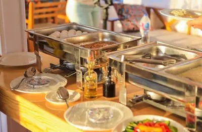 a counter with plates of food on a table at Cobra Nile Sails - Tranquility in Luxor