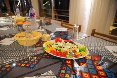 a table with a plate of food on a table at Cobra Nile Sails - Tranquility in Luxor
