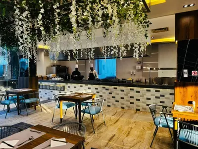 a restaurant with tables and chairs and a bar at Elite Sea Sky Resort in Hurghada