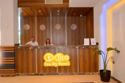 a man and a woman standing behind a bar at Elite Sea Sky Resort in Hurghada