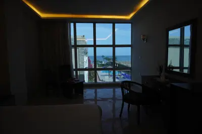 a bedroom with a view of a large window at Elite Sea Sky Resort in Hurghada