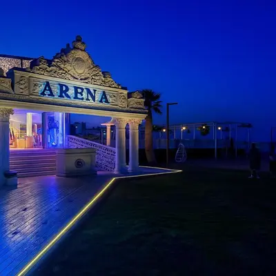 a building with a sign that says arena at night at Selena Bay Prime Stays in Hurghada