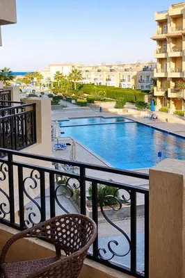 a balcony with a view of a swimming pool at Selena Bay Prime Stays in Hurghada