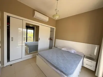 a bedroom with a bed and a large mirror at Makadi Heights Resort in Hurghada