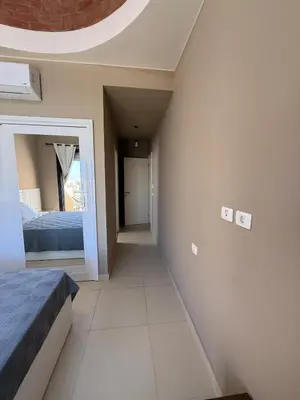 a bedroom with a bed and a mirror on the wall at Makadi Heights Resort in Hurghada