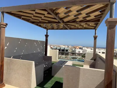 a wooden pergola on the roof of a house at Makadi Heights Resort in Hurghada