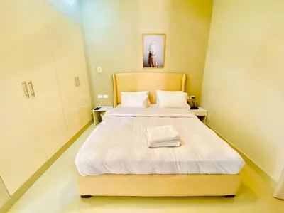 a bedroom with a large bed with white sheets at Luxury villa twaila in Hurghada