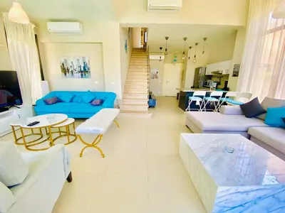 a living room with a blue couch and a table at Luxury villa twaila in Hurghada