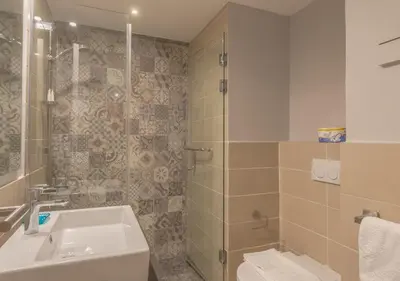 a bathroom with a sink and a shower at Upscale 2BR Mosaique Marina Stay, Yachts & Sea Views in Hurghada