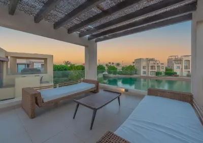 a patio with a bench and a table and a pool at Airy & Bright 4BR Villa in Tawila, El Gouna, Private Pool & Lagoon Access in Hurghada