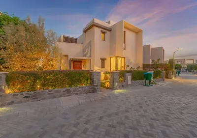 a large white house with a brick driveway at Airy & Bright 4BR Villa in Tawila, El Gouna, Private Pool & Lagoon Access in Hurghada