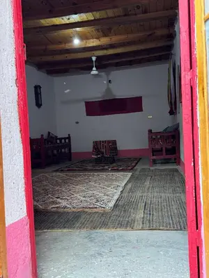 an open door of a room with tables and chairs at Mountain house retreat in Al Aqālitah