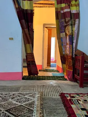 a hallway with colorful curtains and rugs in a room at Mountain house retreat in Al Aqālitah