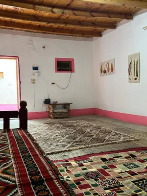 an empty room with a rug on the floor at Mountain house retreat in Al Aqālitah